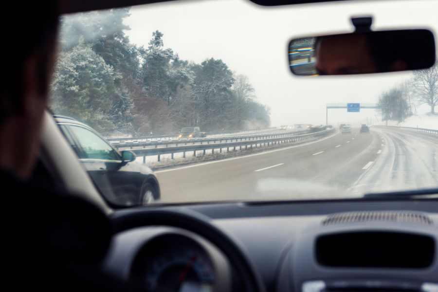 Driving car down snowy German highway