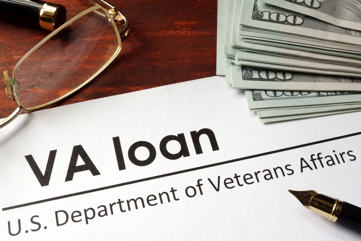 VA loan paperwork, pen, and money