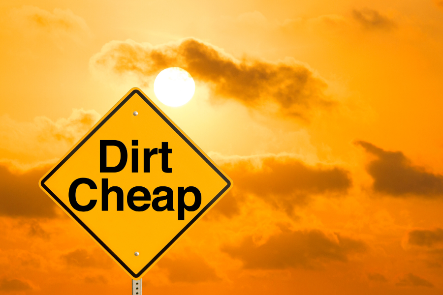 orange and yellow sky with sign saying dirt cheap