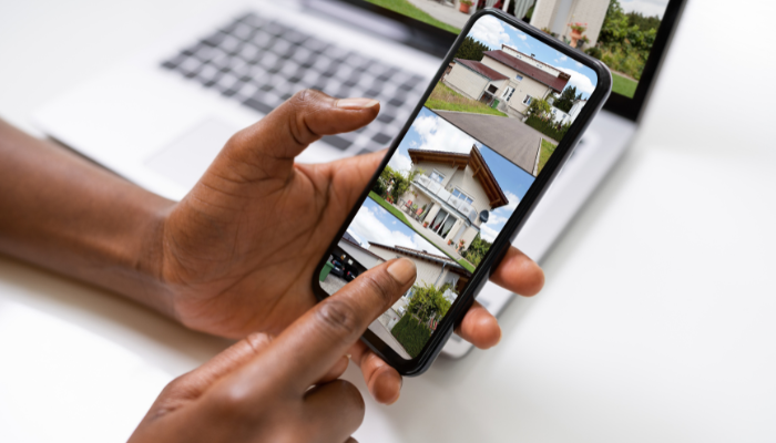 Scrolling through home listings on phone and computer.