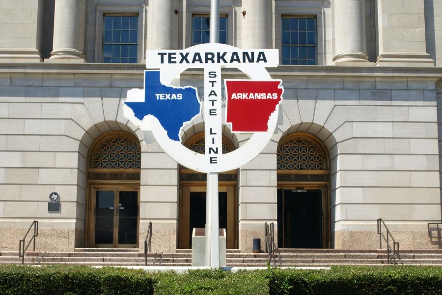 Texarkana sight on the state line of Texas and Arkansas in front of State Line Post office and federal courthouse white stone building
