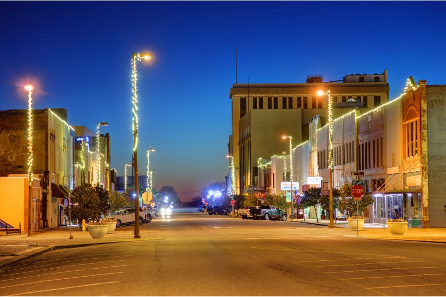 old buildings on main street of Texarkana at night light up with strings of lights
