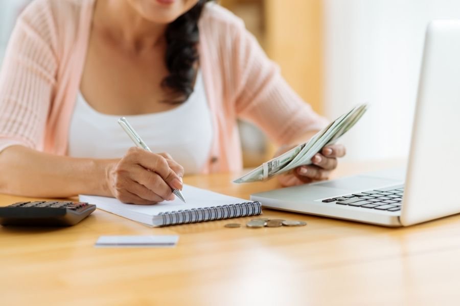 woman with list creating ousehunting budget