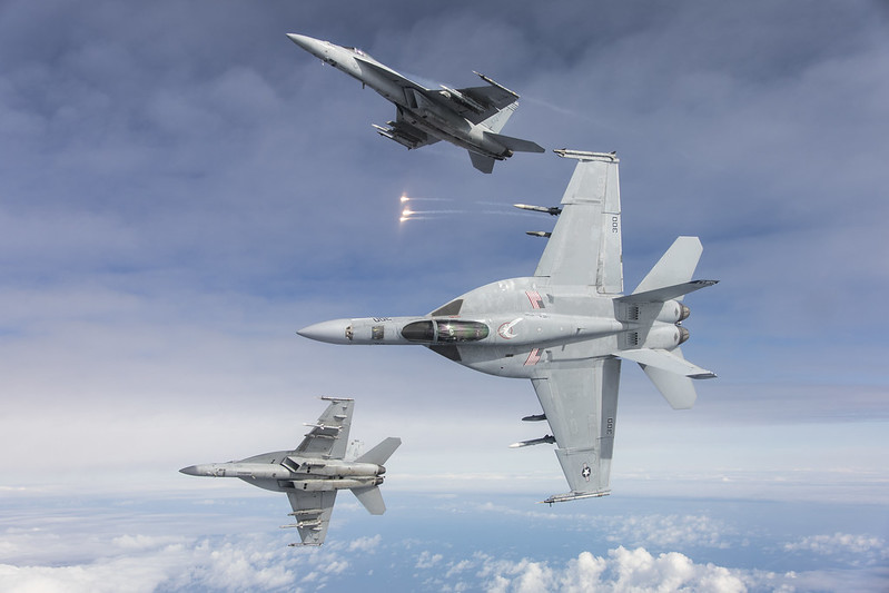 F/A-18E aircraft from Naval Air Station (NAS) Lemoore fly in formation over the Pacific Ocean