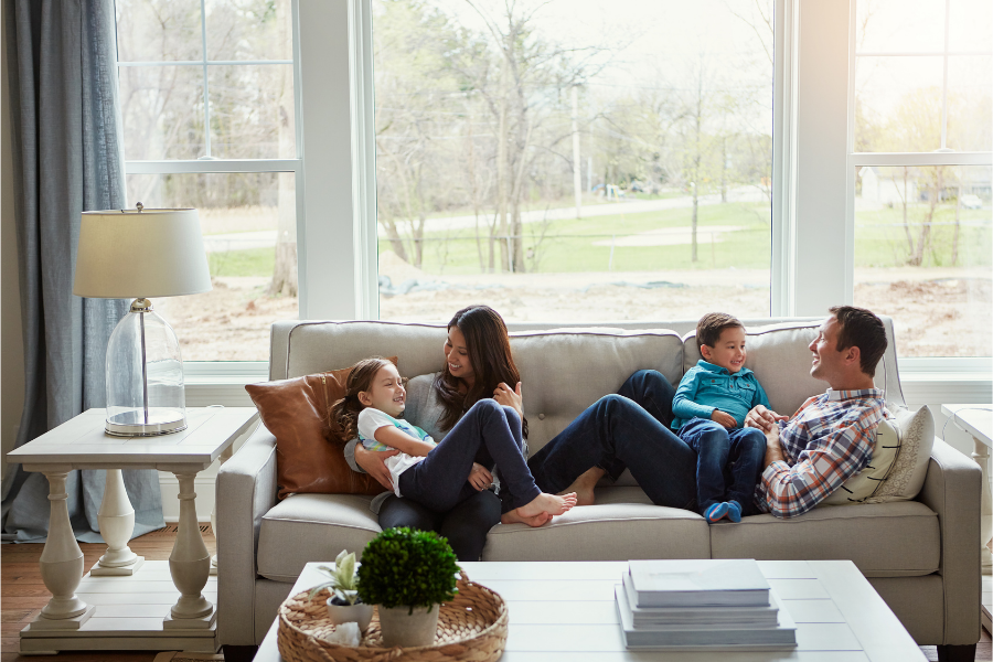 family relaxing on couch in new home