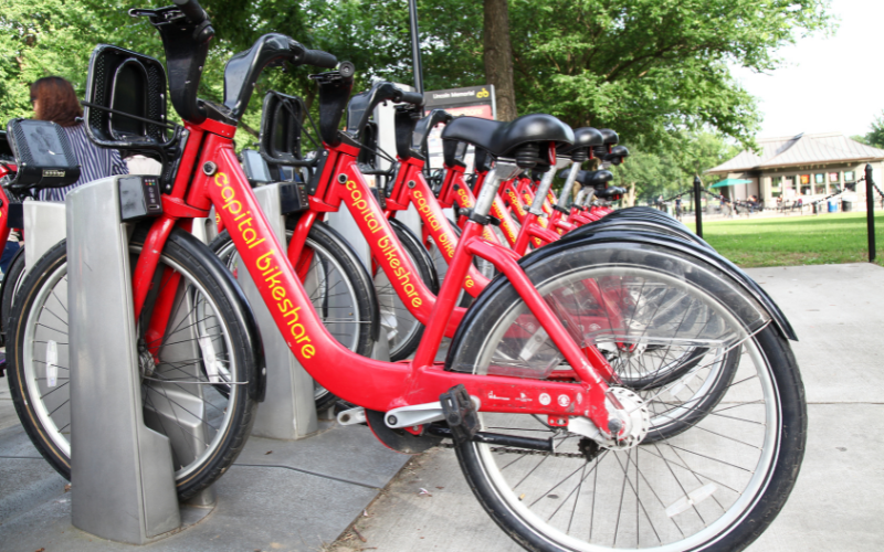 A row of red bikes lined up in bike stand, DC's capital bikeshare bikes.