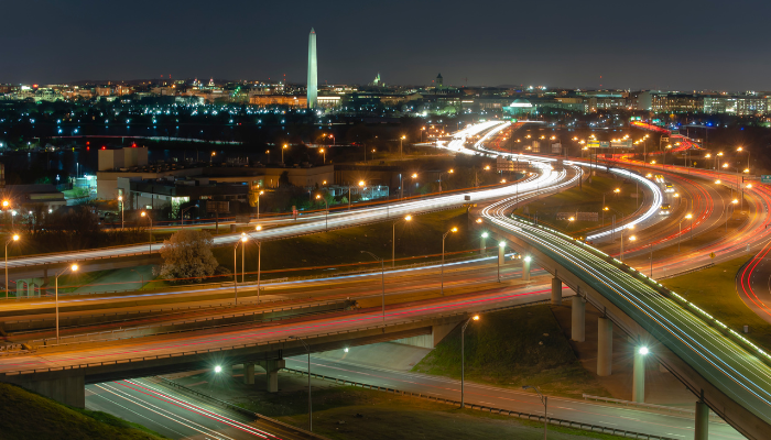 Aerial of evening traffic in Alexandria and DC highways lights and cars with Washington Monument