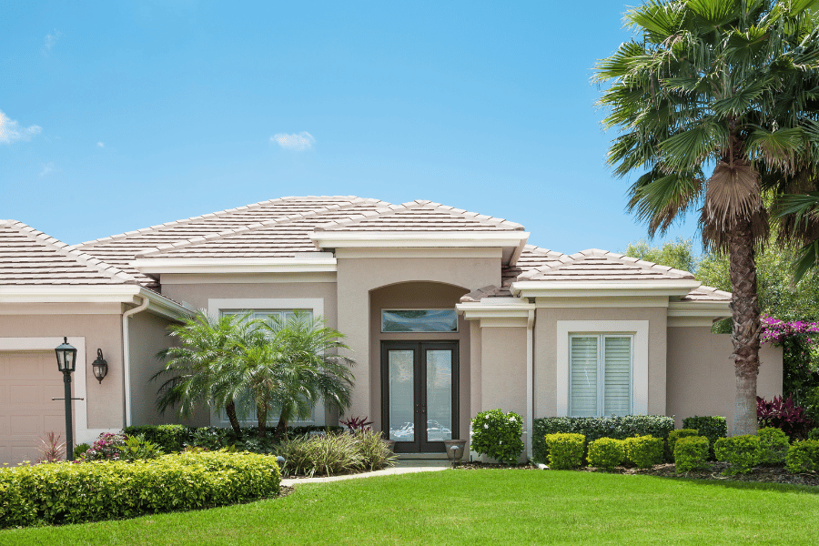 beige stucco home with palm trees