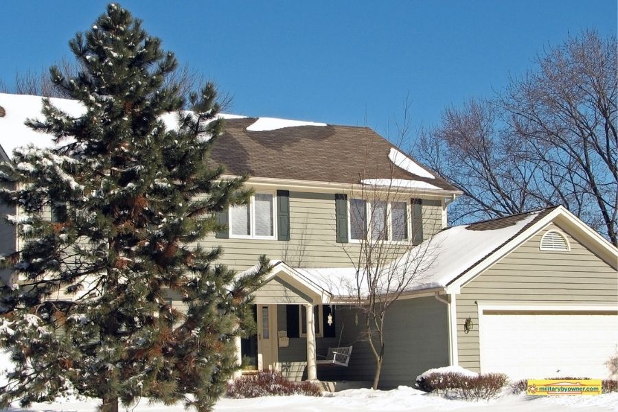 Fort_Greely_housing two-story beige house and trees with snow