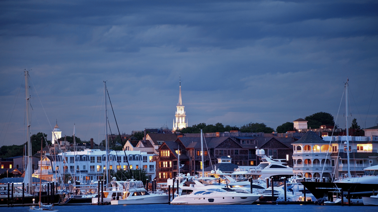 buildings and boats near shore in evening in Newport County, Rhode Island