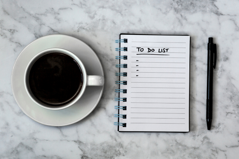 checklist with pen and coffee cup