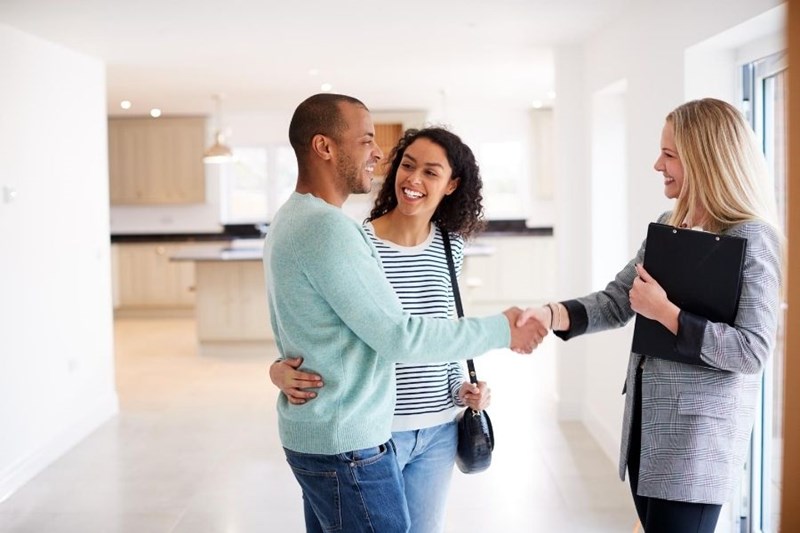 young couple shaking hands with buyer's agent