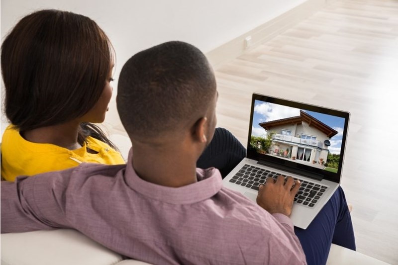 couple looking at new home on laptop