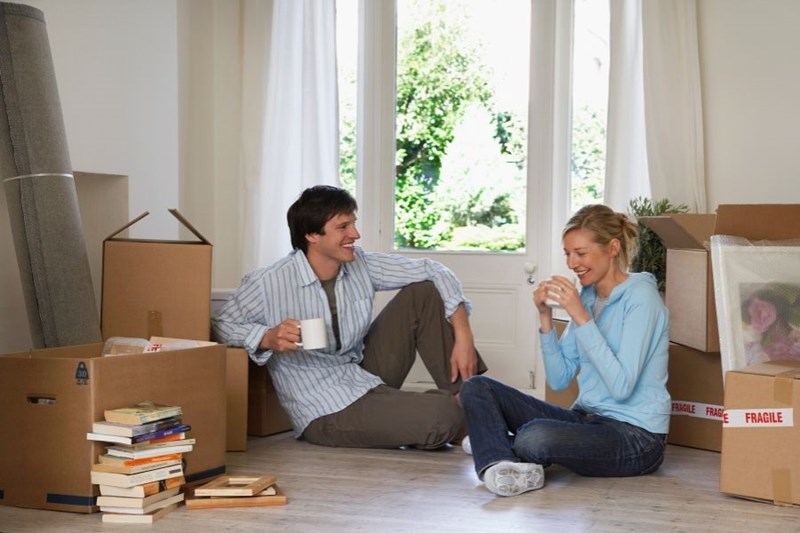 couple with moving boxes in rental