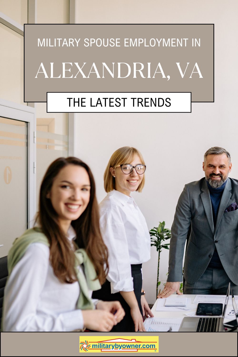 Three working professionals standing around table with laptops with text, Military Spouse Employment in Alexandria, VA The Latest Trends