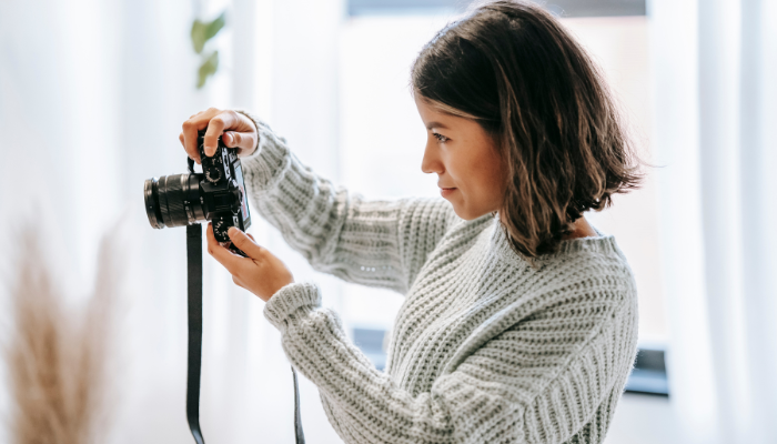 Woman taking professional photos of house to sell.
