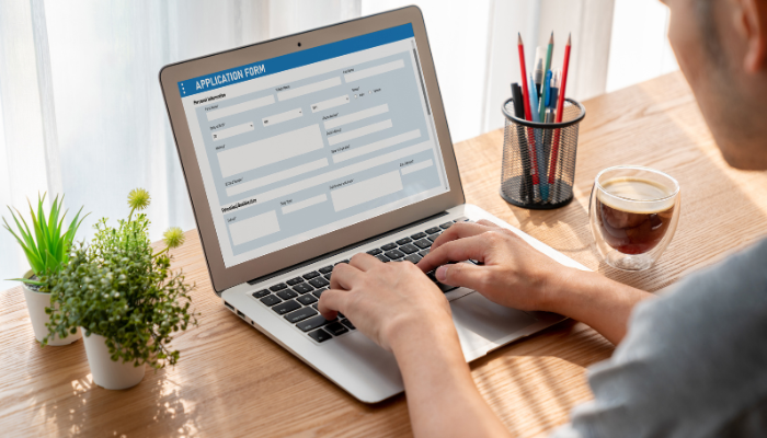 Man fills out housing application online. 