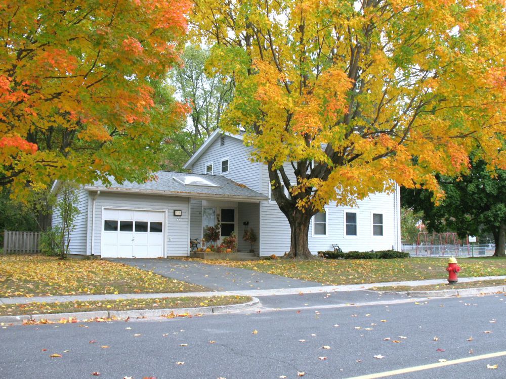 WestoverFamilyHousing white house in neighborhood and trees with fall foliage