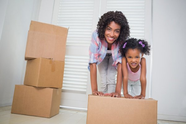 mother and daughter with boxes moving into new rental home