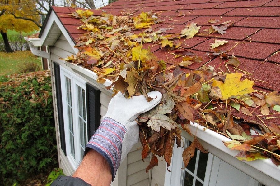 clearing leaves from gutter