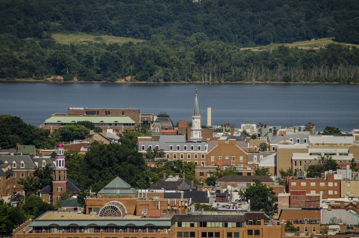 aerial view of Alexandria VA, historic red brick buildings with river and trees