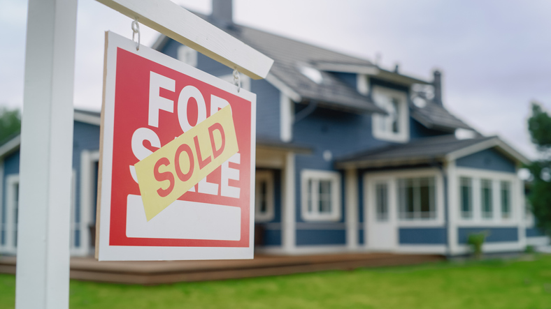 house with sold sign
