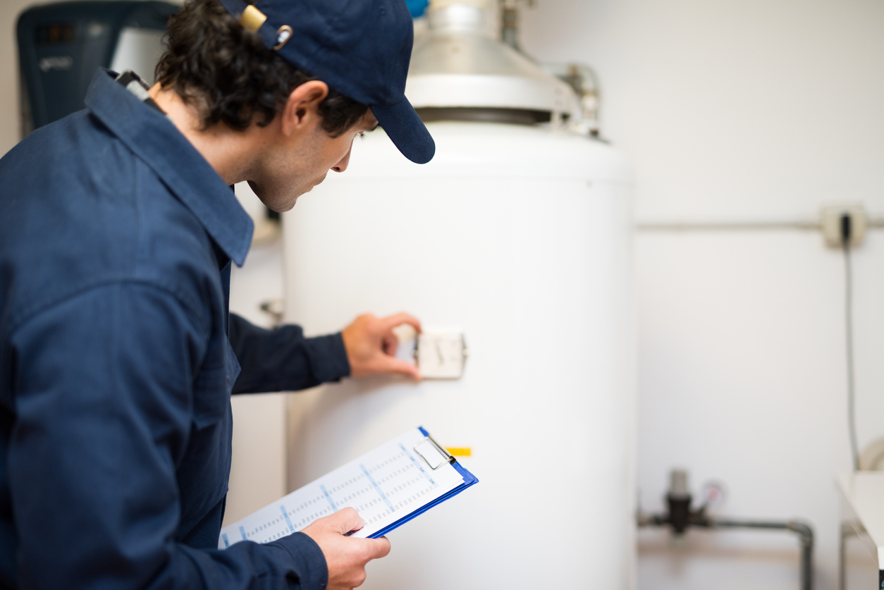 home inspector looking at water heater