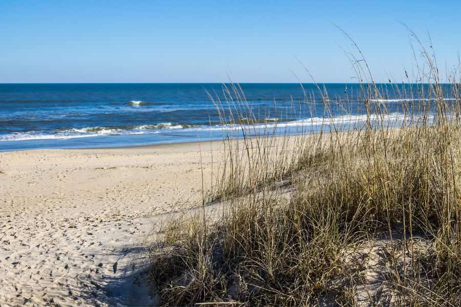 sand and water with blue sky near Norfolk Naval Base in Virginia
