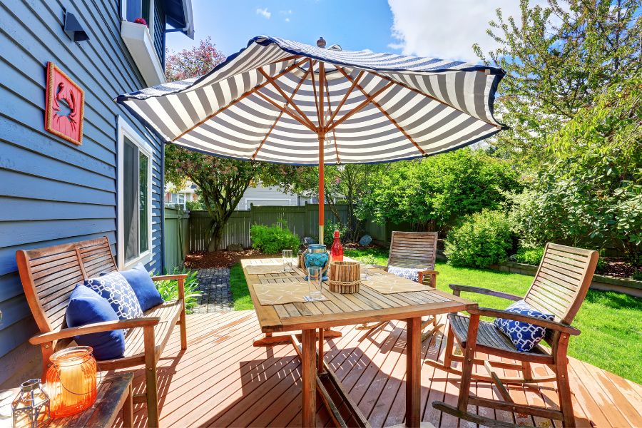 back deck with covered table and chairs and umbrella